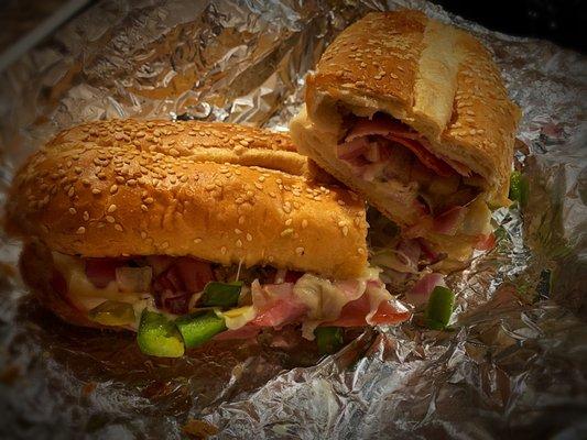 Deluxe Sub: ham, pepperoni, onions, mushrooms, green olives, green peppers, cheese & mayo.