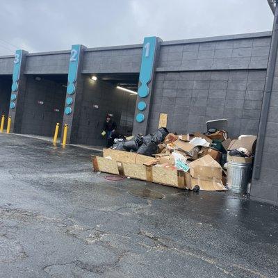 Back of the car wash with a pile of dumped garbage. This looks sketchy to me.