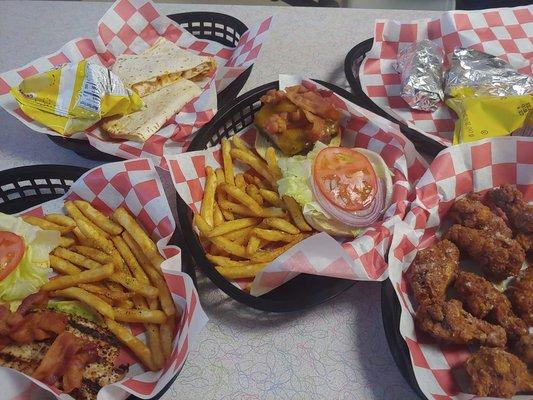 Variety of our foods. Bacon cheeseburger, chicken quesadilla, chicken sandwich, buffalo chicken wings