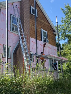 Insulation process before new vinyl installation.