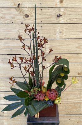 A stunning design accented with protea and crespedia. Call today! 757-548-4800