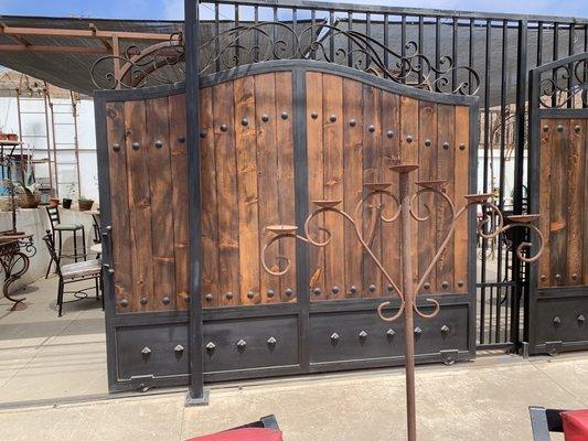 Custom wrought iron sliding gate with tong and groove vertical boards.