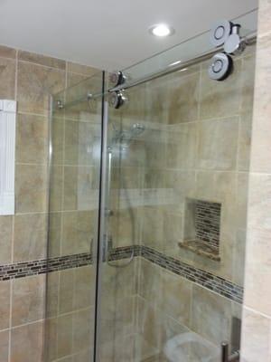 Bathroom install sliding glass shower door.