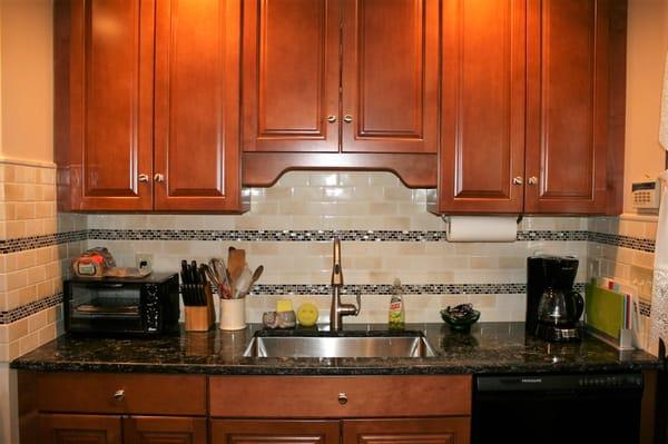 New quartz countertop with under mount stainless steel sink and single handle Moen faucet.