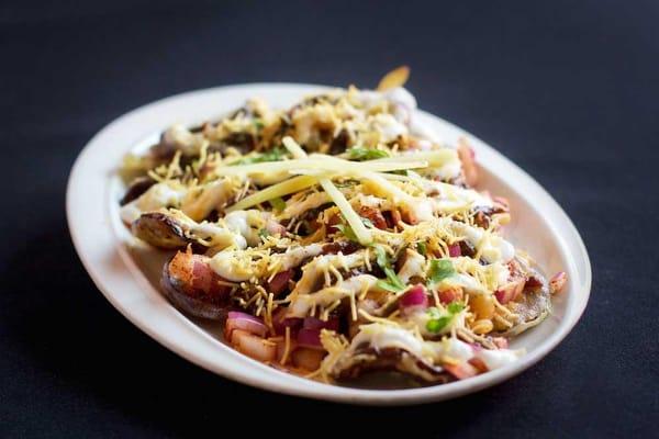 Eggplant Chaat...Crispy baby eggplant with toppings of yogurt, tamarind, and red onion.