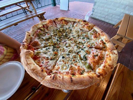 Large pie with green olives, feta, and fresh garlic