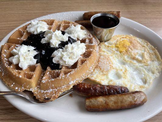 Waffles with blueberries, eggs, and sausage