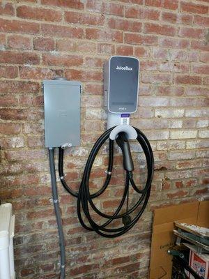 This customer installed a charger right next to the driver's door in his garage for easy access to the charging cord!