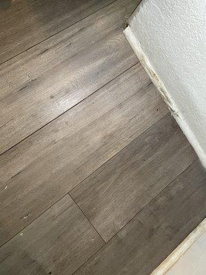 Water damage on floor, baseboards.