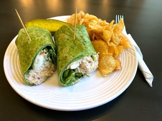 Tuna Salad on a spinach wrap with jalapeño kettle chips and a pickle.