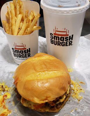 A smash combo with fries and a drink. The burger's messy but delicious!