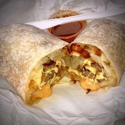 Breakfast burrito w/ sausage, eggs, melty cheese & hash browns. Classic good, I recommend.