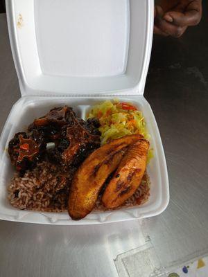 Ox tail, rice with beans/peas, cooked cabbage and carrot medley, fried plaintain --so delicious! This was their small size.