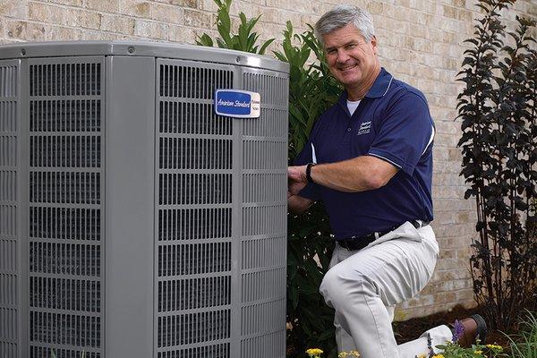 Technician working on AC repairs in Houston.