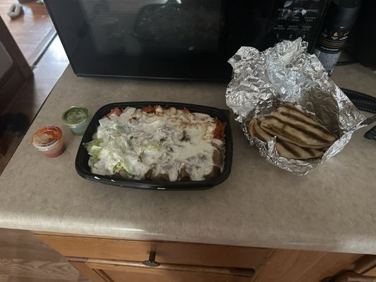 Combo Lamb and Chicken over Rice. With a side of pita, hot sauce and green sauce.