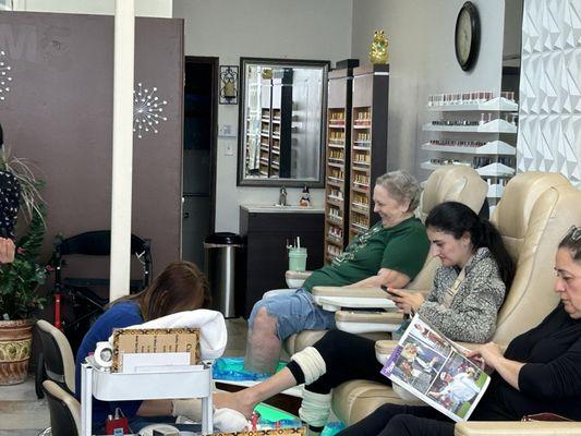 Wife waiting for Sue to finish, as others are enjoying a foot bath.