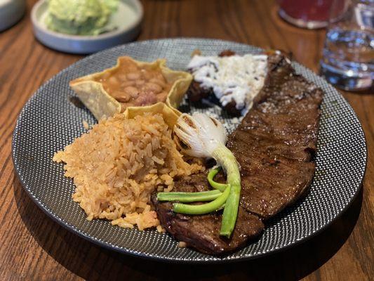 Carne asada entree with rice, bacon pinto beans and fried plantains