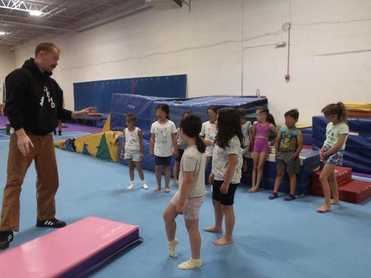 Coach James leads the birthday celebration group in fun pre-lunch gym time.