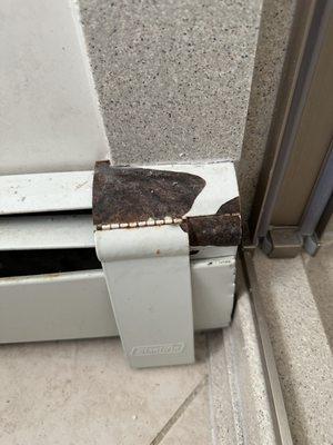 Rusty radiator cover permanently glued to the new shower wall trim