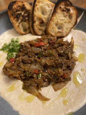 Hummus topped with ribeye and fire roasted eggplant