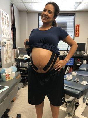 Pregnant? No problem! Our beautiful, pregnant mom here is sporting RockTape to help support the added load of her baby girl after treatment!