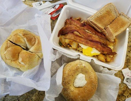 Sesame bagel with cream cheese, sausage, egg & cheese on a roll and breakfast platter