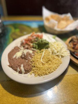 Side plate: rice, beans, pico, lettuce, cheese, sour cream & guac