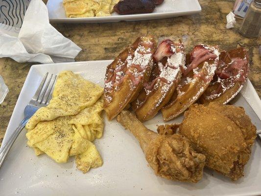 Strawberry waffles with chicken and a side of scrambled eggs. Mates beef sausage was terribly burnt.