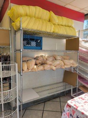 These racks are always full of  large bags of corn husks over the holidays!