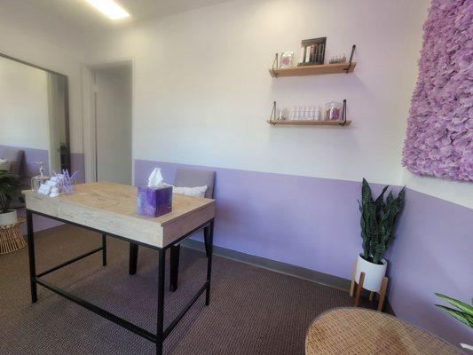 Super cute, clean, cozy, color coordinated waiting area.