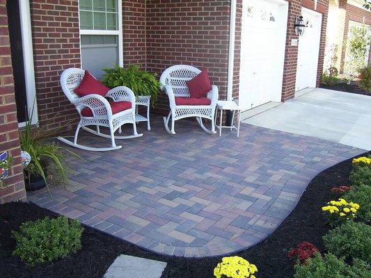 Paver entryway with sitting area.