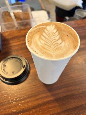 Mocha w/oat milk & latte art ‍  The secret ingredient that's makes it delicious, top left corner