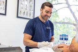 Dr. Oltman prepping a patient prior to a procedure.