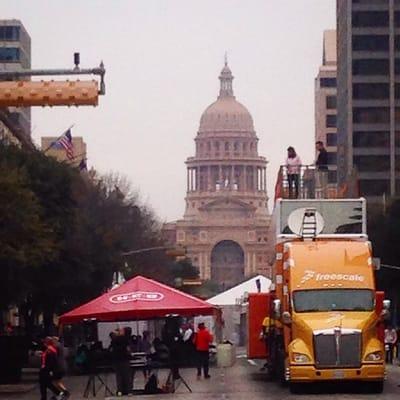 View of the Capitol from the Finish Line Festival. Freescale truck, HEB tent, food trucks, training groups, DJ, mariachi band.