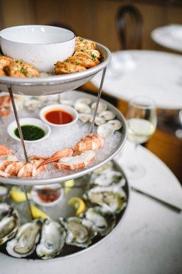 seafood towers featuring oysters, clams, shrimp, seafood charcuterie, lobster, and seafood tartare