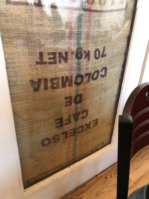 Upside coffee burlap sack in an interior door.