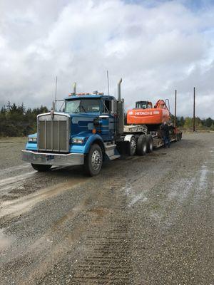 One of our older trucks A-10 lowboying an excavator to get some dirt work done at a local jobsite.