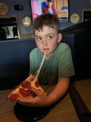 Kid eating cauliflower crust pizza