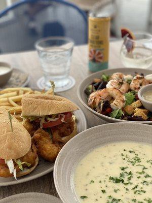 Oyster po boy, clam chowder, and mixed green salad with grilled shrimp.