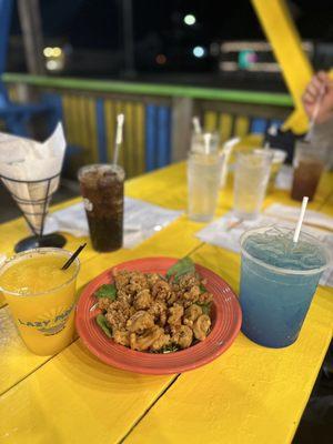 Calamari with frozen mango margarita & electric shark bucket