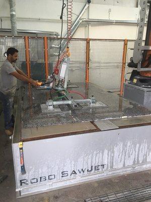 A mass granite professional putting another slab on the table to start the fabrication process #massgranite