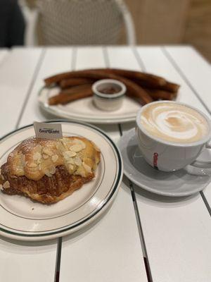 Churros, Nutella dip, almond croissant, and a cappuccino