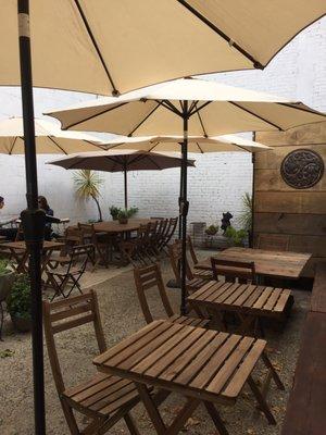 Back patio with tables and umbrellas