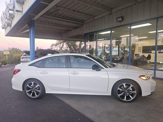 My brand new 2025 Civic Hybrid Touring (white exterior and grey interior).