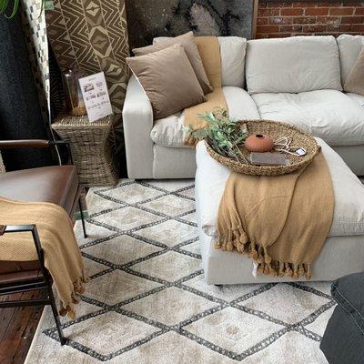 Savesto Sectional, assorted rugs, and home decor