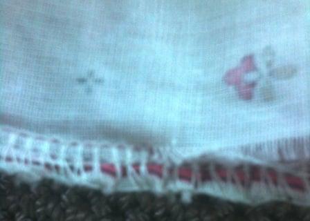 You can clearly see in this photo where the material was not totally in the stitching and therefore the ruffle ripped.