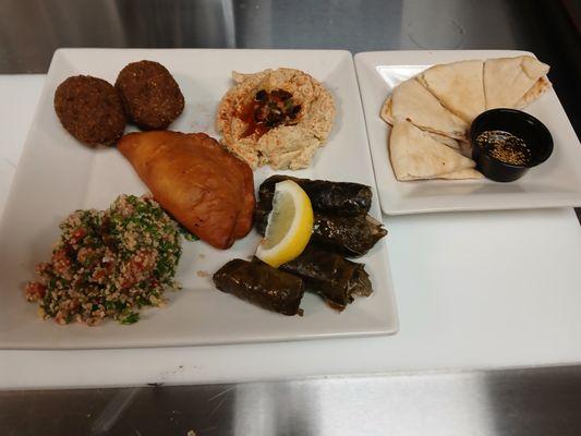 Chickpeas sampler, Sambousek, grape leaves, Tabouleh. Kibbe, hummus and a side of pita bread with zataar dip