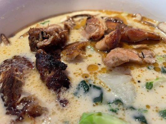 Coconut curry soup with pork and chicken.