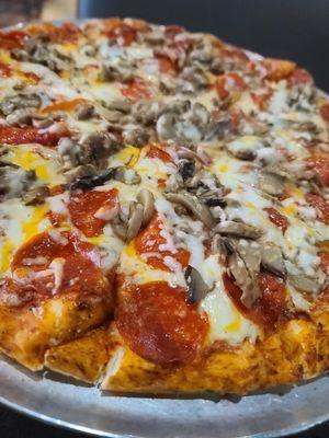 Large pepperoni and mushroom pizza