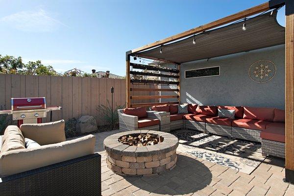 Built and plumbed propane firepit. Built pergola.